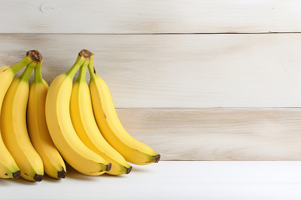 Ripe bananas on white wooden background, a Food & Drink Photo by AlyaAnd