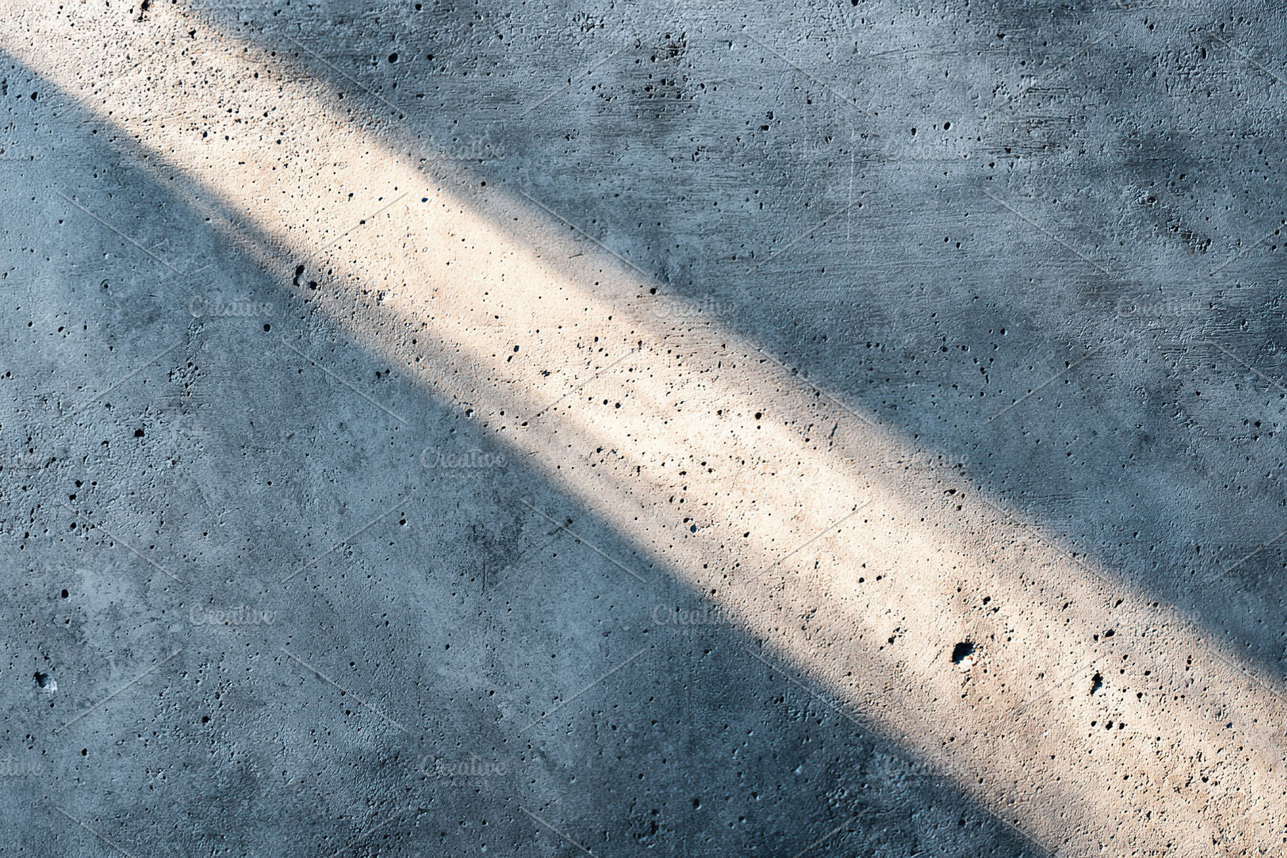 Concrete surface illuminated by sunlight creating a textured pattern in the aft, a Background Photo by AlyaAnd