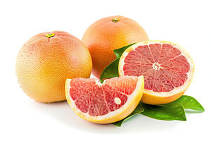 Fresh and tasty grapefruits with green leaves on white background, a Food & Drink Photo by AlyaAnd