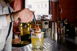 Flaming cocktail fresh alcohol drink hands glass, a Person Photo by Photo Drive Studio