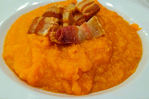 Mashed pumpkin with crispy bacon on white plate, a Food & Drink Photo by DanFLCreativo
