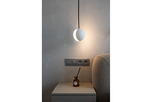 Minimal bedside wall lamp above