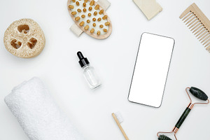 Mockup for beauty and wellness design. Smartphone with blank white screen surro, a Photo by matucha