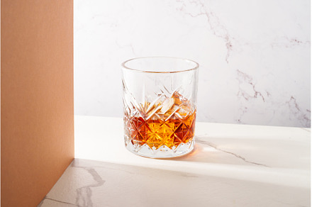 Whiskey with ice cube in the glass