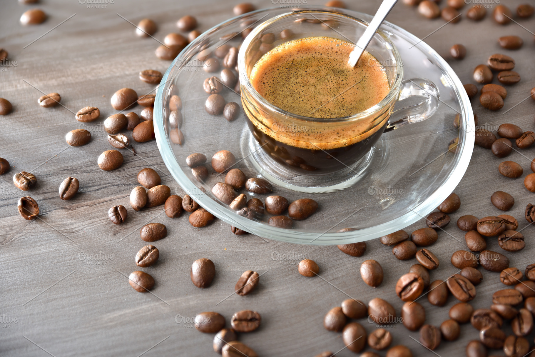 Coffee cup in glass and glass saucer on wooden table, a Food & Drink Photo by Davizro's Market