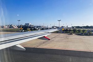 View from airplane window overlooking Sydney airport in Australia under clear b, a Photo by AS photostudio