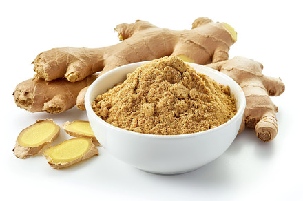 Ground dry ginger in bowl isolated on white background, a Food & Drink Photo by AlyaAnd