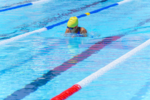 Swimmer child swims breaststroke swimming style in a race swimmi, a Sports & Recreation Photo by Casanowe-studio