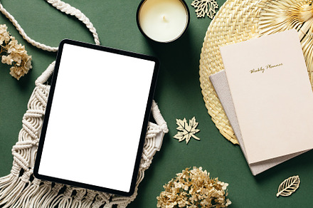 Feminine workspace with digital tablet pad mockup, paper notebook, candle, macr, a Beauty & Fashion Photo by photoguns