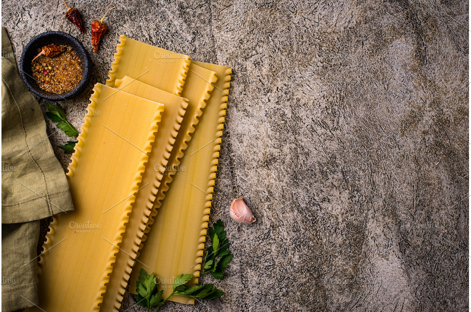 Uncooked lasagna pasta with cooking, a Food & Drink Photo by Yulia Furman
