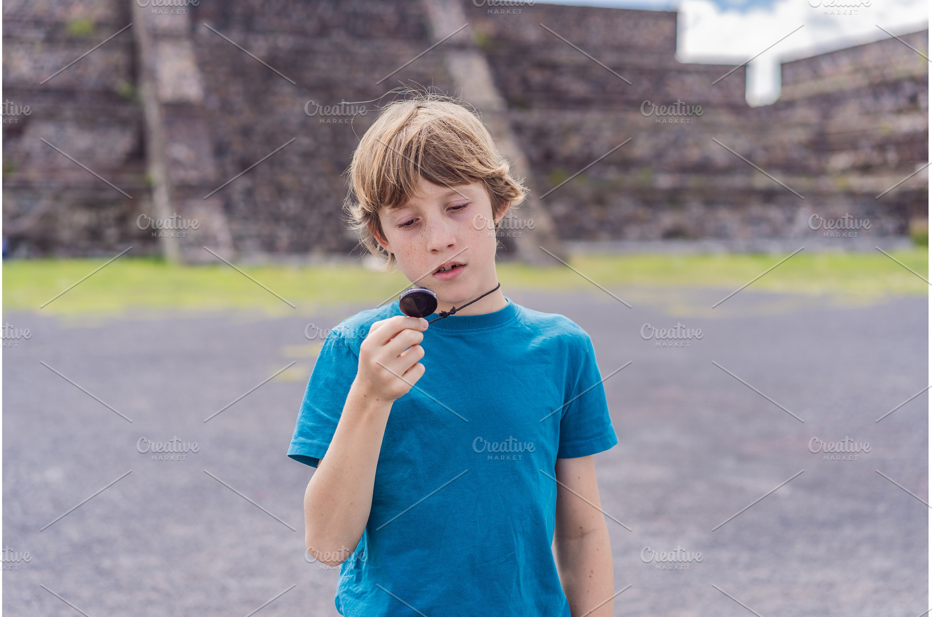 Boy tourist holding and observing a, an Architecture Photo by Elizaveta Galitskaya