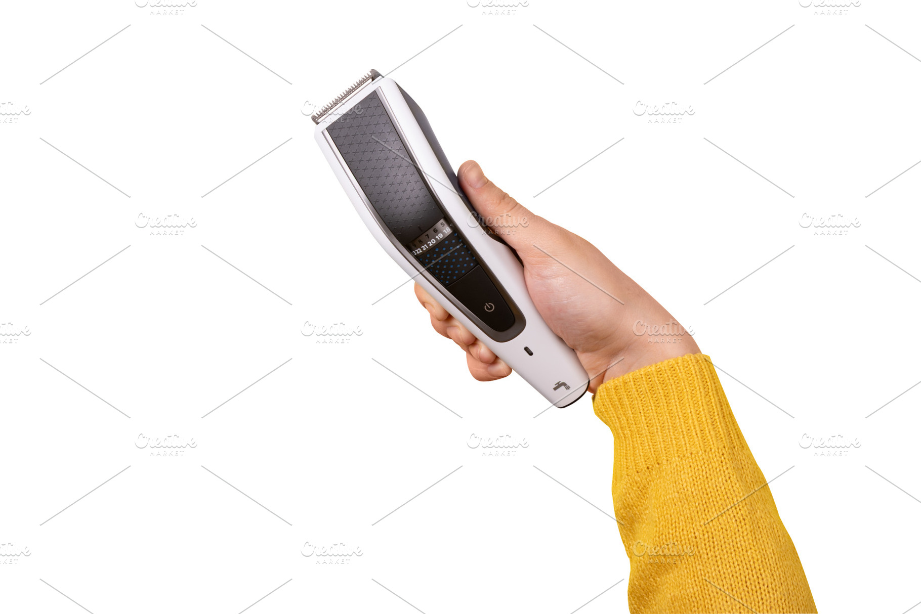 hand holding an electric hair clipper in angled position on whit, a Beauty & Fashion Photo by Ales Munt