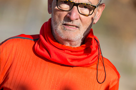 Active senior runner in orange sweatshirt in nature resting., a Sports & Recreation Photo by RF Images