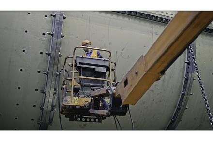 Worker on telescopic lift at factory, an Industrial Photo by Media Whale Stock