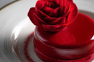 Romantic Valentine's Day dessert with red rose, elegant glazed m, a Photo by Studio ANNA