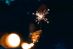Hand holding sparkler featuring lights, fairy lights, and twinkle lights