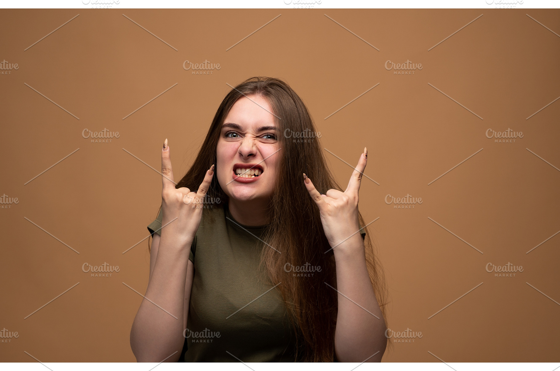 Young woman showing rock and roll, a Person Photo by volodymyrshtun13795