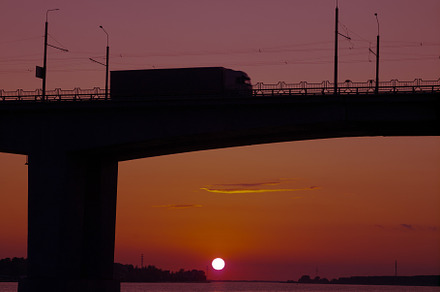 Silhouette of a bridge over water ov containing cityscape, river, and bridge, a Transportation Photo by oleghz
