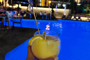 Refreshing cocktail by a luminous pool in a vibrant night atmosphere, a Photo by AS photostudio