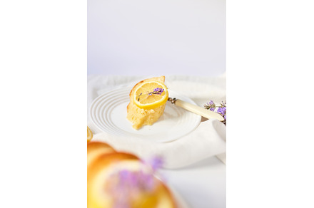 Piece of lemon cake on white table, a Food & Drink Photo by IlliaBondarPhotography