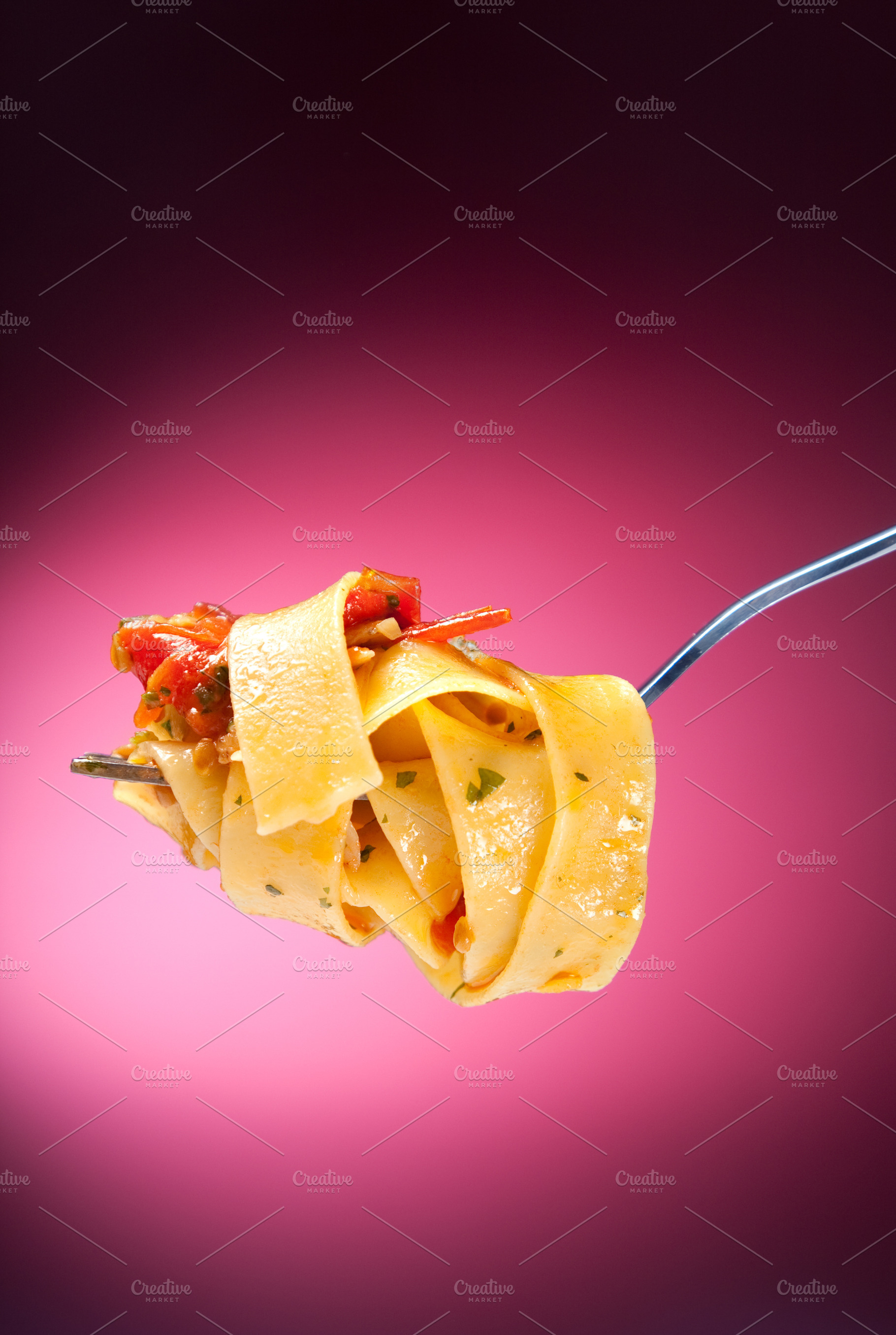 Tagliatelle with clams on a red background, a Food & Drink Photo by FoodStock
