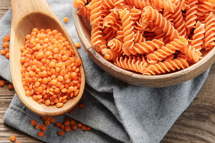 Fusilli red lentil pasta on a old wooden background., a Food & Drink Photo by Olena Rudo