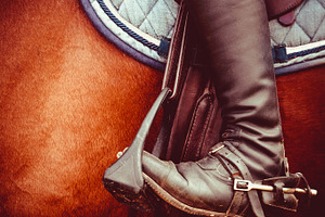 Jockey riding boot, saddle, stirrup