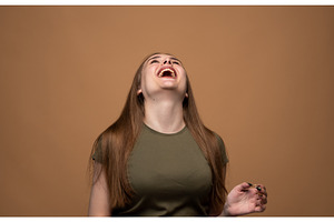 Young woman bursting with laughter, a Person Photo by volodymyrshtun13795