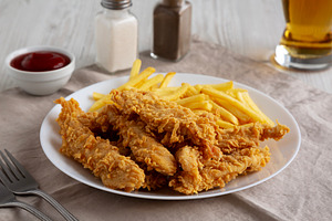Homemade Chicken Strips with Fries on a Plate, low angle view., a Food & Drink Photo by LiudmylaChuhunova