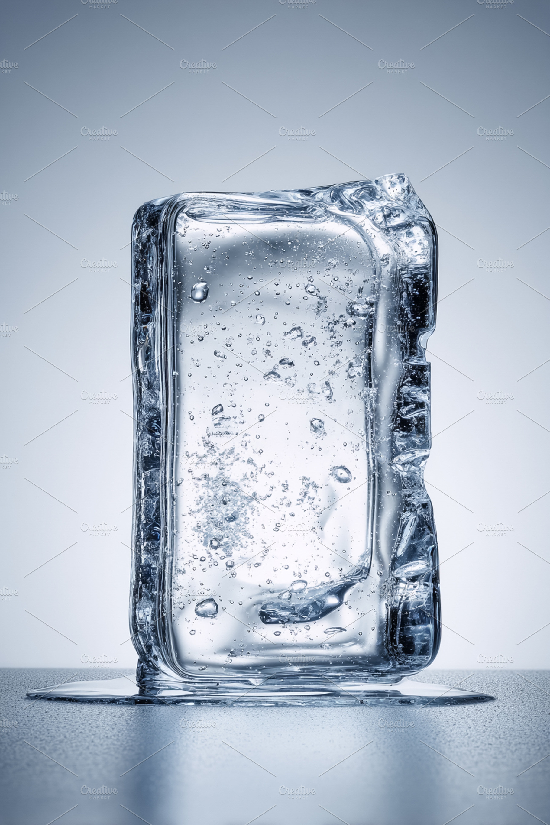 Ice block on a surface melting, forming a puddle of clear water,, a Photo by Studio ANNA