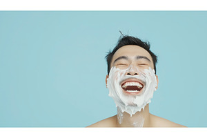 A joyful Asian man with shaving, a Person Photo by Sergey Kotenev
