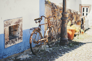 Rusty bike on cobblestone alley, a Wallpaper Photo by SkyNext