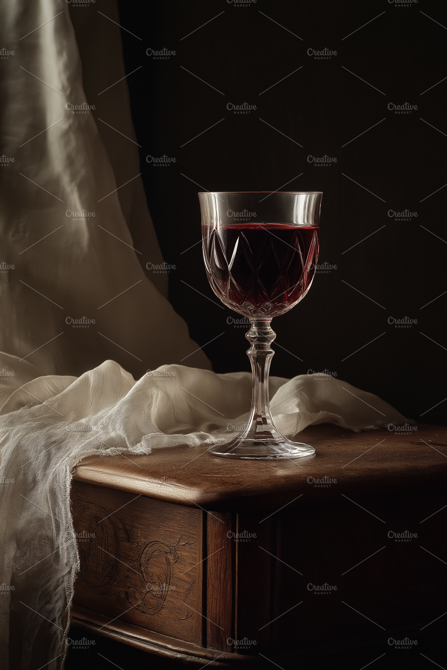 Carved crystal wine glass holding red wine on an old wooden table. Creating a m, a Food & Drink Photo by Studio ANNA