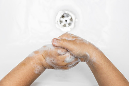 Child washing hands containing hand, bubbles, and germs