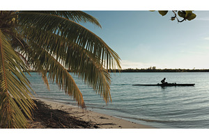 Polynesian fisherman paddling va'a, a Sports & Recreation Photo by Goinyk