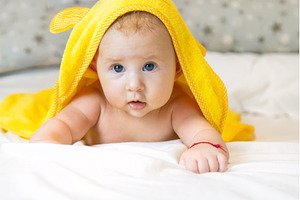 Little baby in a towel after bathing, a Person Photo by yanadjana