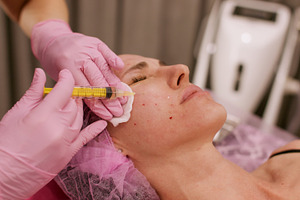 Beauty injection therapy treatment hand woman face, a Person Photo by Photo Drive Studio