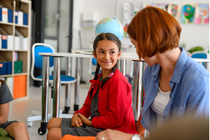 Teacher talking with schoodlgirl in, a Person Photo by HalfPoint