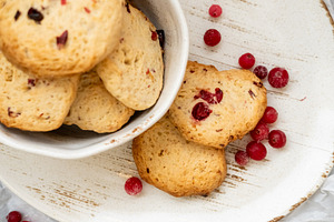 Homemade biscuits baked treats plate red berries, a Food & Drink Photo by Photo Drive Studio