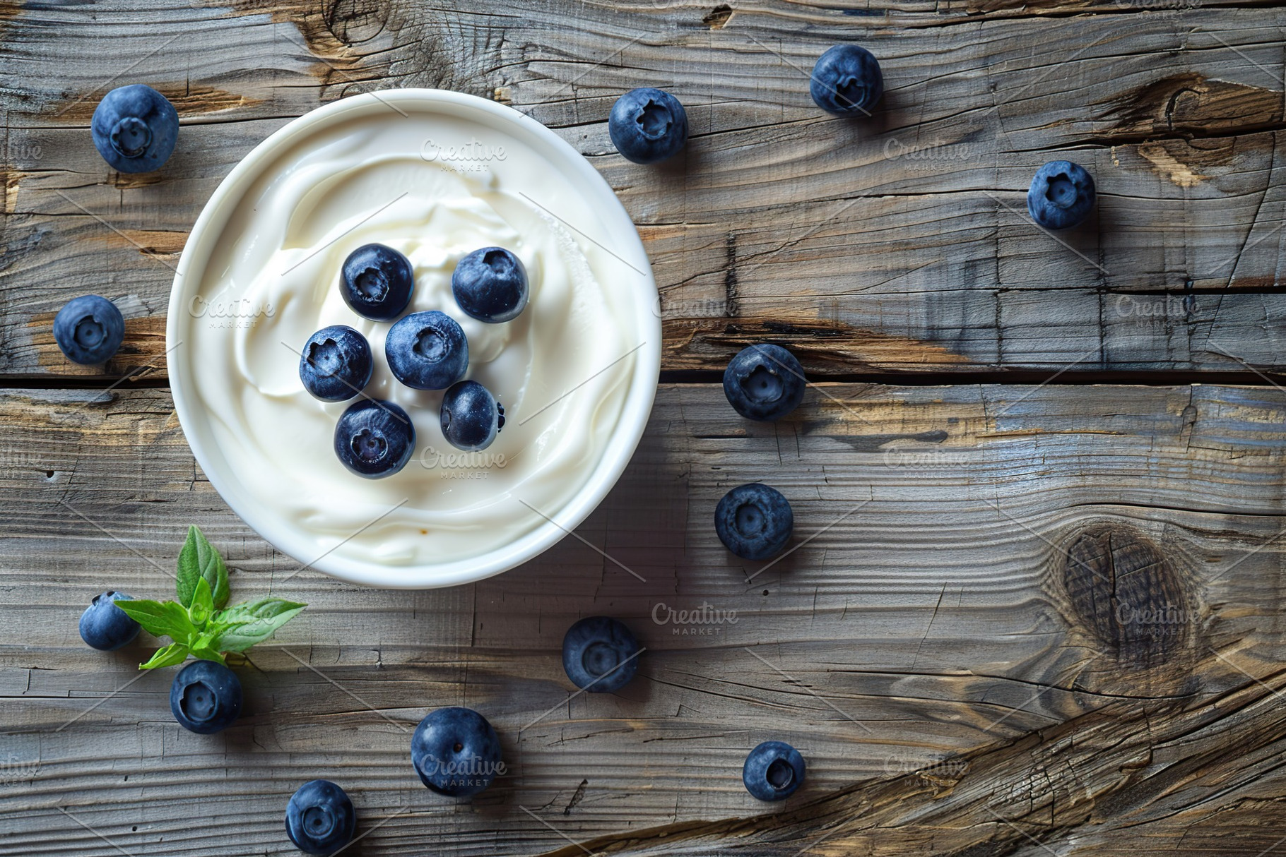 Bowl with white yogurt and ripe blueberries on wooden table, a Food & Drink Photo by AlyaAnd