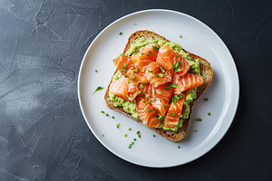 Toast bread with salted salmon and guacamole avocado on grey background, a Food & Drink Photo by AlyaAnd