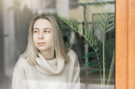 Sad girl near window thinking about something, a Person Photo by Olena Rudo