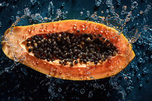 Fresh papaya splashes in water, a Photo by Pavel_design