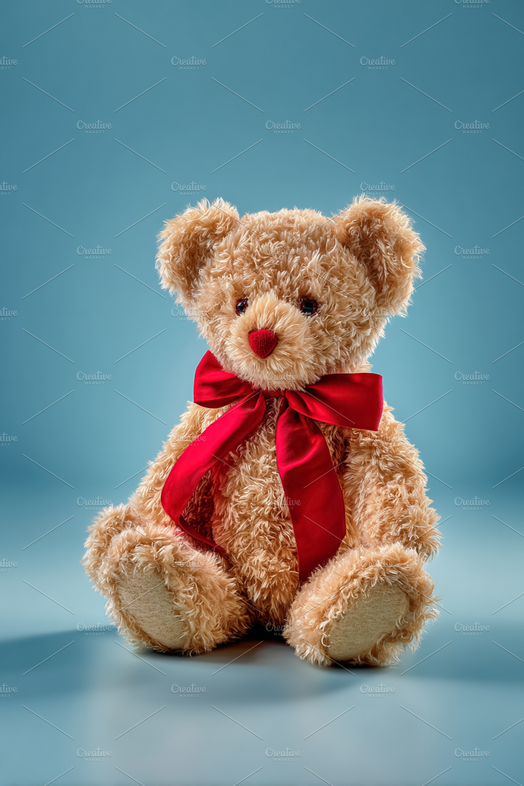 Teddy bear with a red bow and heart nose celebrating Valentine's, a Photo by Studio ANNA