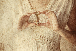 Woman holding old key in a hands