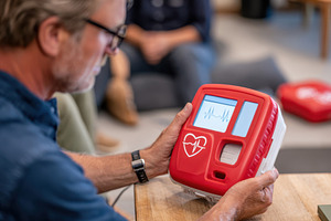 Person using an automated external defibrillator, a Health & Medical Photo by AlyaAnd