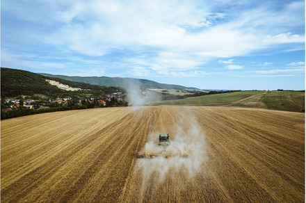 Aerial view of a harvester working, an Industrial Photo by HalfPoint