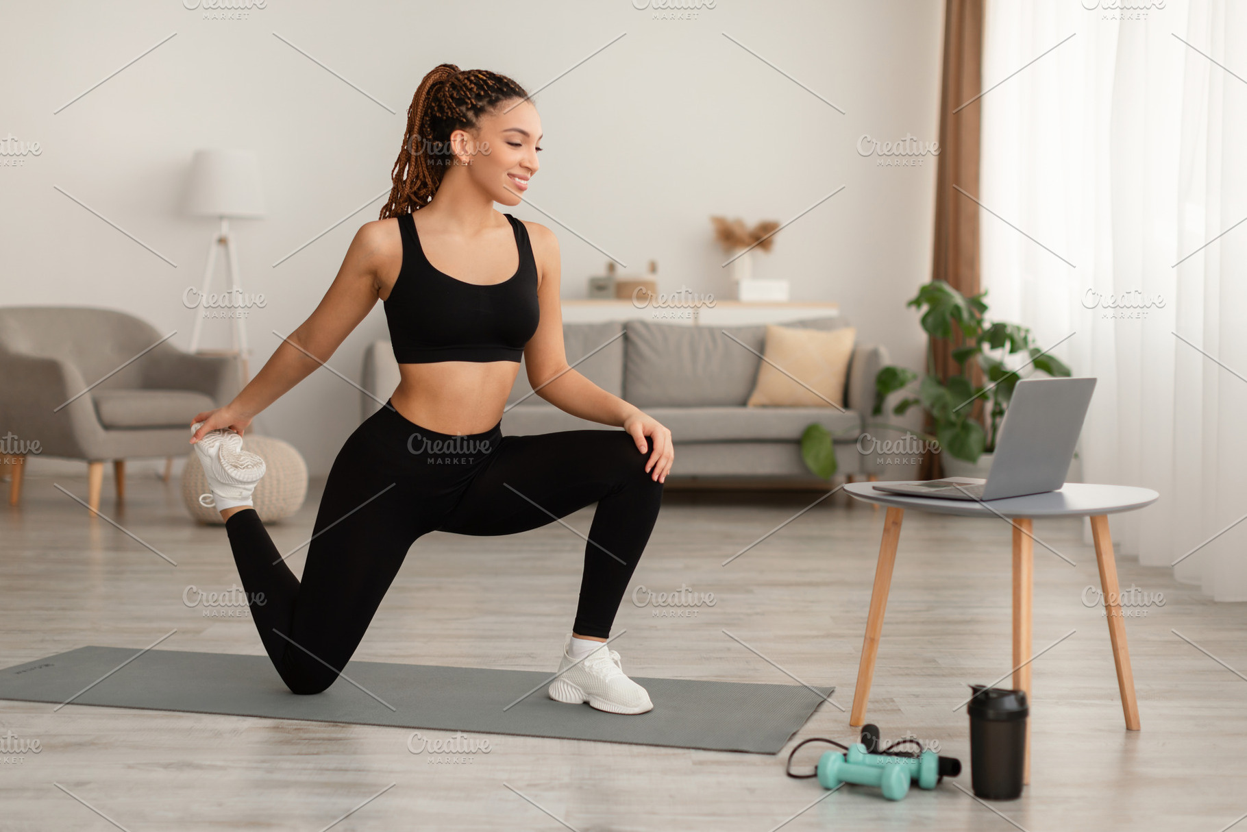 Happy African Lady Doing Hip And Leg Exercises At Home, a Photo by Prostock-Studio
