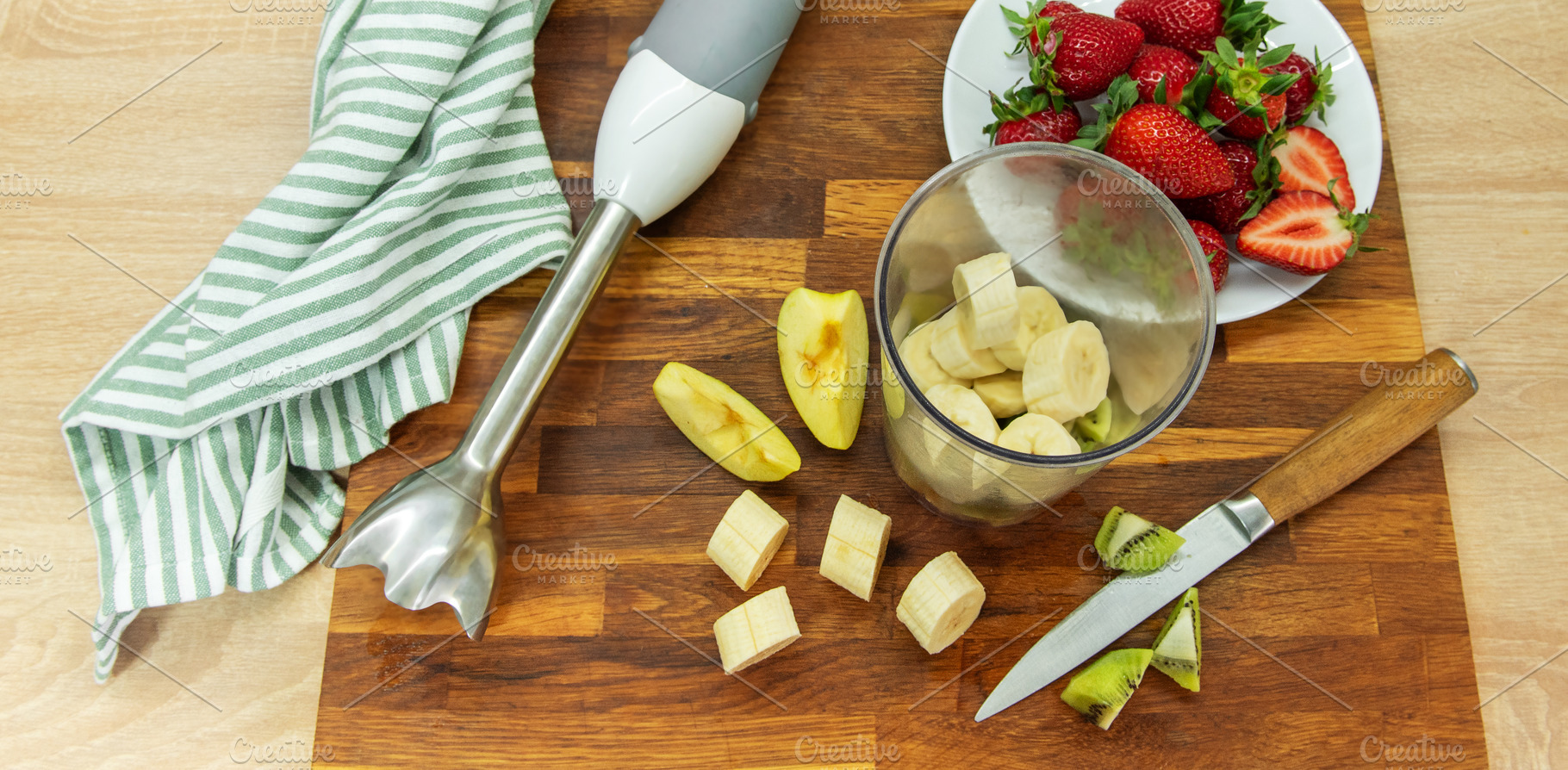 Preparing fruit smoothie with banana strawberries and kiwi, a Food & Drink Photo by Olena Rudo