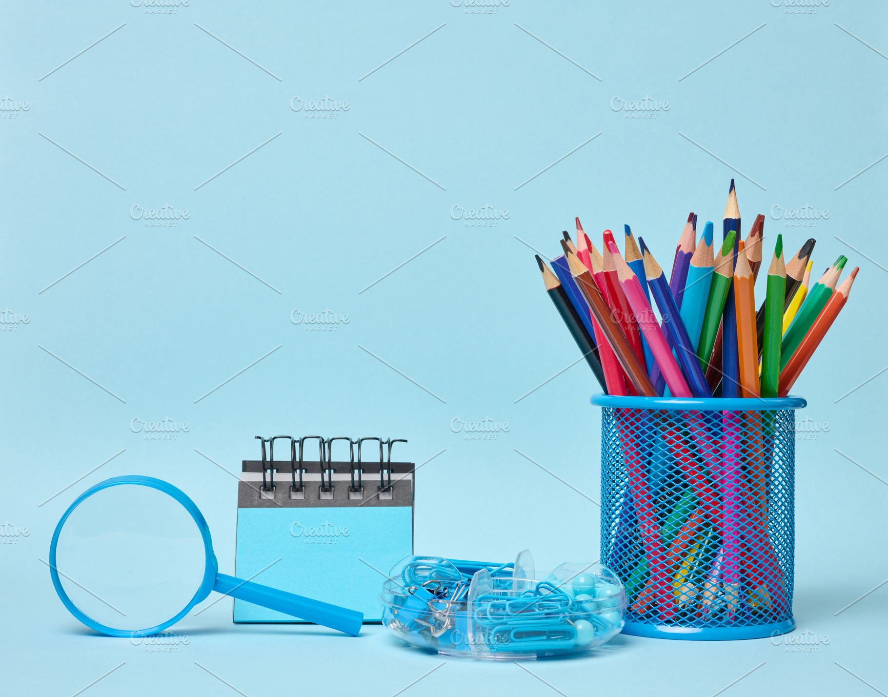 Set of office supplies including colored pencils in a glass, mag, a School & Education Photo by ndanko